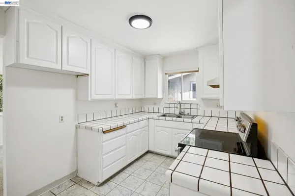 a kitchen with a sink a stove a microwave and cabinets