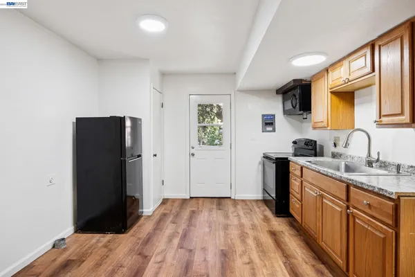 a kitchen with a refrigerator and a sink