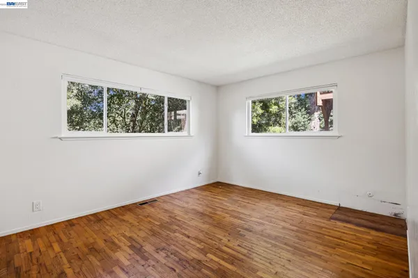 a view of room with window and hardwood floor
