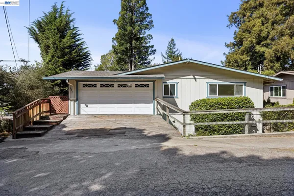 a view of a house with a yard and garage