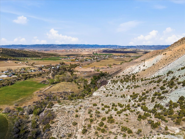 811 East Canyon Road Mayfield, UT 84643 - Photo 50 of 57 Expansive undeveloped land featuring a varied topography including sloped terrain, scattered low-lying vegetation, and distant agricultural fields