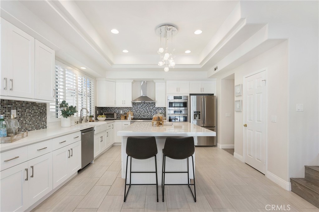 17 Calle Cabrillo Lake Forest, CA 92610 - Photo 12 of 44 a kitchen with stainless steel appliances kitchen island granite countertop a sink and cabinets