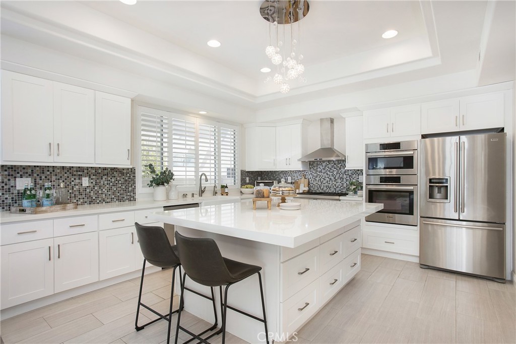 17 Calle Cabrillo Lake Forest, CA 92610 - Photo 14 of 44 a kitchen with white cabinets and stainless steel appliances