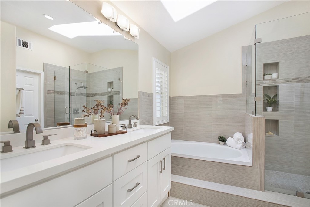 17 Calle Cabrillo Lake Forest, CA 92610 - Photo 23 of 44 a bathroom with double vanity sinks a mirror and a bathtub