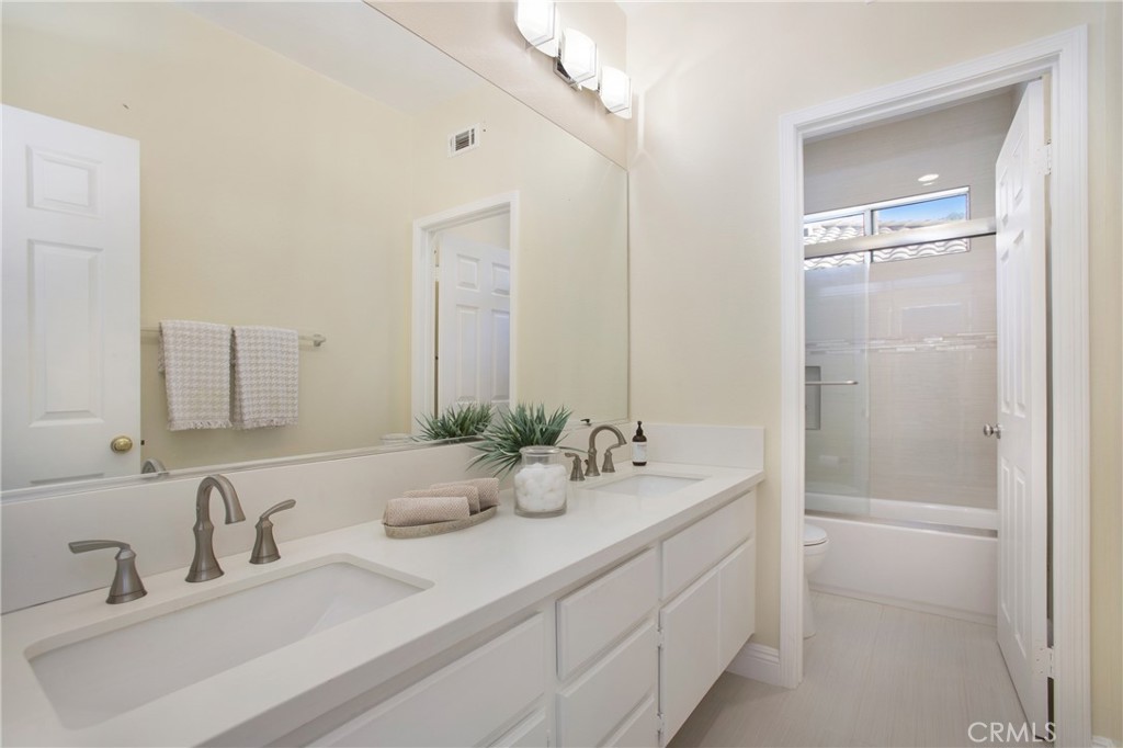 17 Calle Cabrillo Lake Forest, CA 92610 - Photo 26 of 44 a bathroom with double sink and a mirror