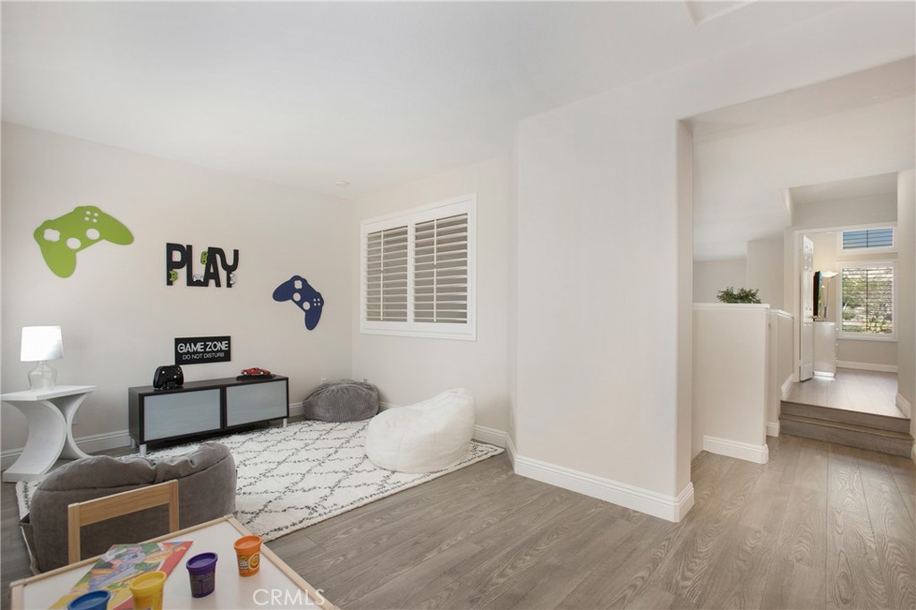 17 Calle Cabrillo Lake Forest, CA 92610 - Photo 27 of 44 a bedroom with furniture and a wooden floor