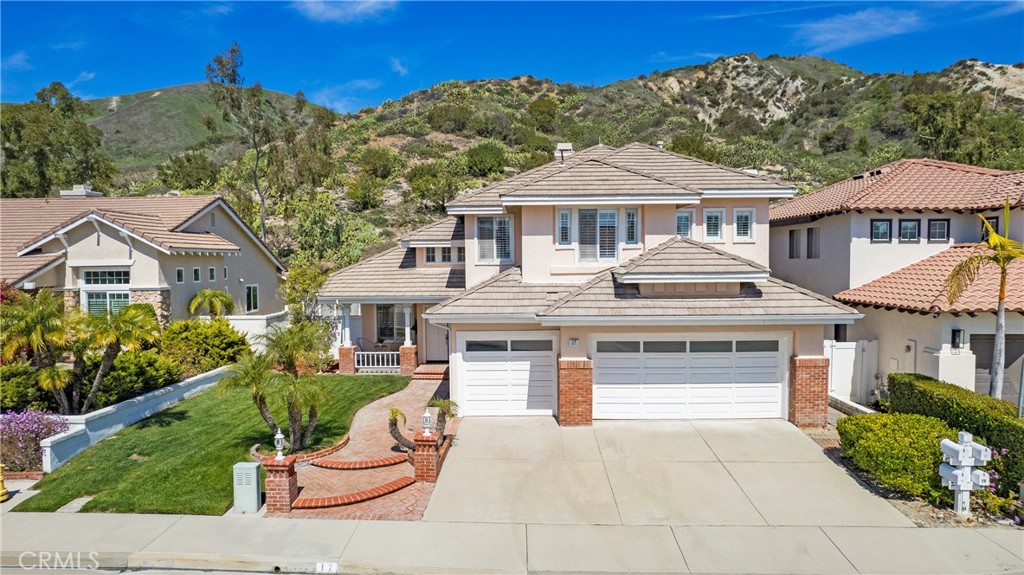 17 Calle Cabrillo Lake Forest, CA 92610 - Photo 34 of 44 a front view of a house with a yard and garage