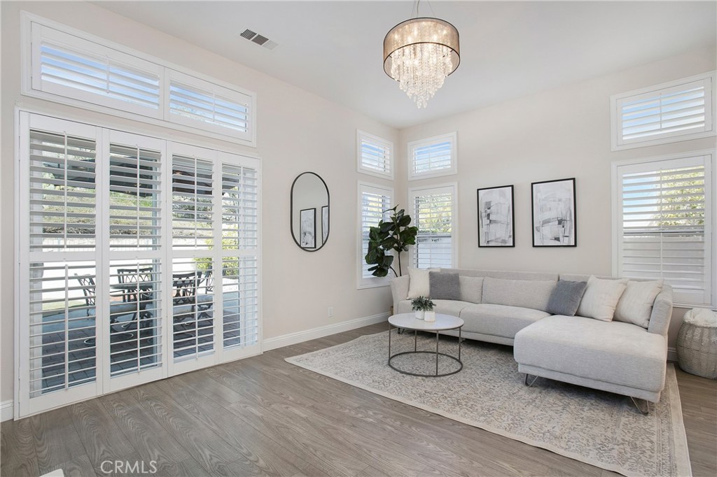 17 Calle Cabrillo Lake Forest, CA 92610 - Photo 9 of 44 a living room with furniture a window and a chandelier