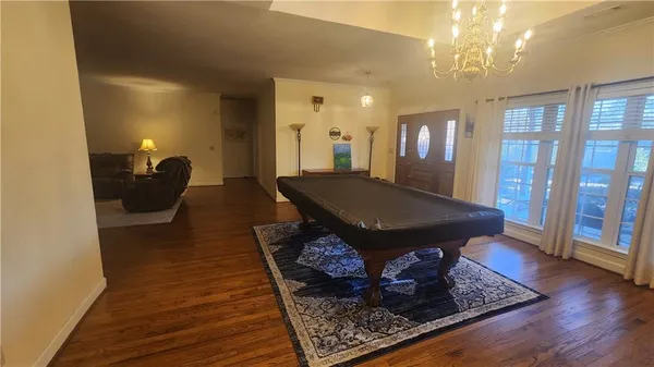 a living room with furniture rug and wooden floor