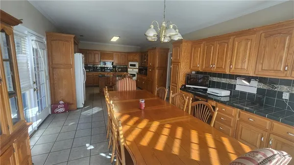 a kitchen with stainless steel appliances granite countertop a refrigerator a stove and a sink