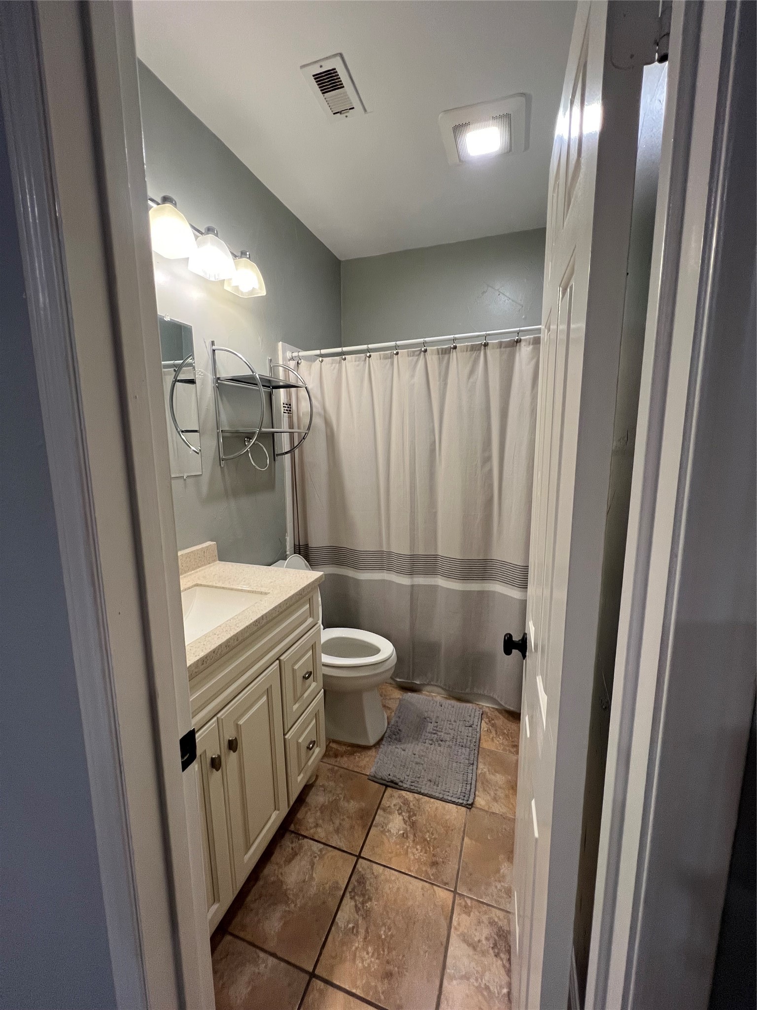 2414 Longview Street, Unit 202 Austin, TX 78705 - Photo 13 of 17 a bathroom with a granite countertop sink toilet and shower