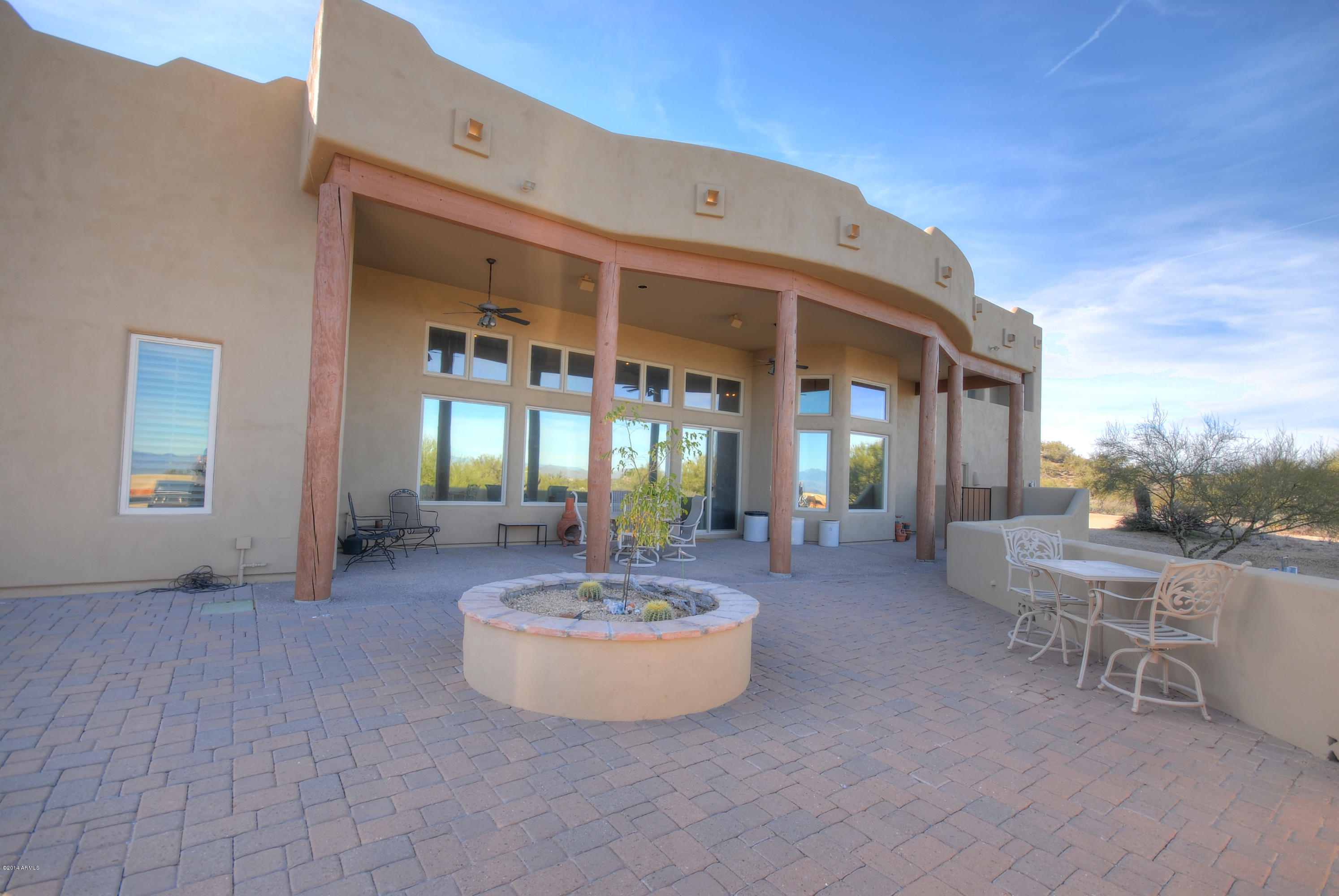 13502 East Jomax Road Scottsdale, AZ 85262 - Photo 31 of 50 a view of a patio with table and chairs with wooden floor and fence