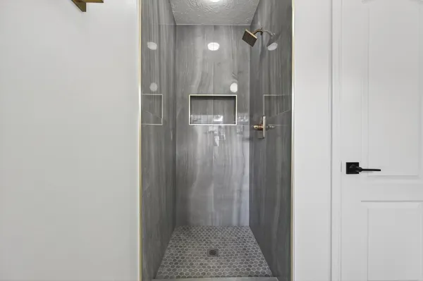 a bathroom with a shower and a sink