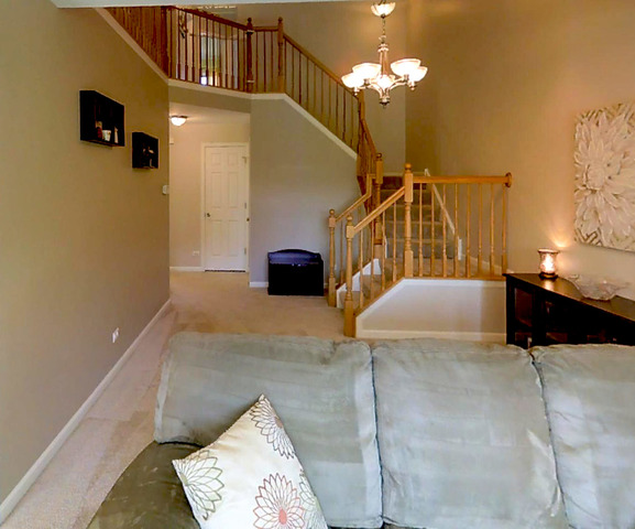 3129 Raphael Court St. Charles, IL 60175 - Photo 6 of 17 a bedroom with a bed and a chandelier