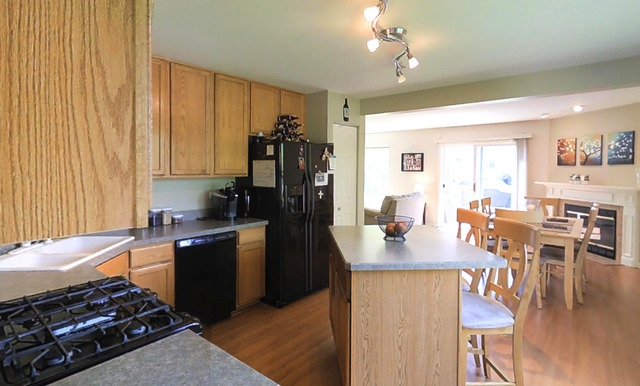 3129 Raphael Court St. Charles, IL 60175 - Photo 9 of 17 a kitchen with a stove a sink dishwasher and a refrigerator with wooden floor