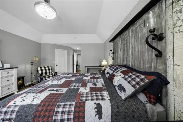 a bedroom with a bed and a chandelier