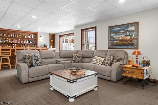 a living room with furniture ceiling fan and a window