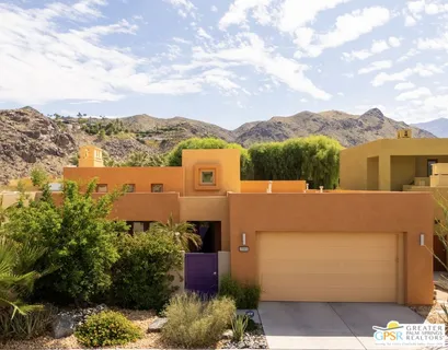 a view of a house with a yard and mountain view