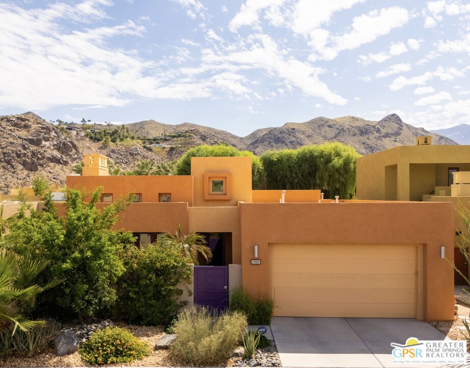 a view of a house with a yard and mountain view