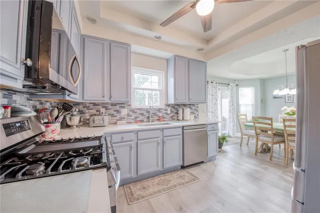 a kitchen with a sink stove and cabinets