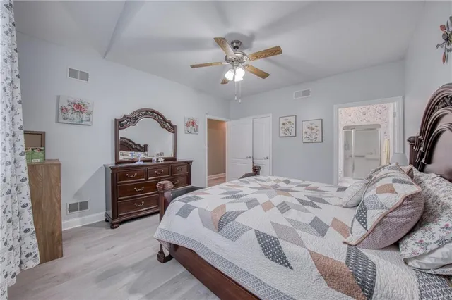 a bedroom with a bed and a chandelier