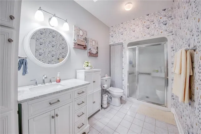 a spacious bathroom with a toilet sink and a mirror
