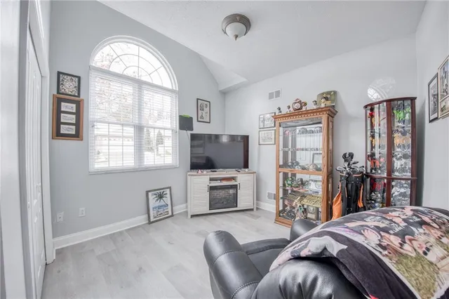 a bedroom with furniture and a window