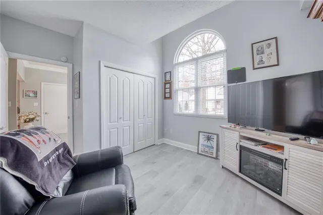 a bedroom with furniture and a flat screen tv