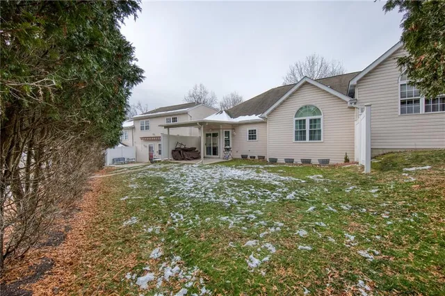 a view of a house with a yard and potted plants