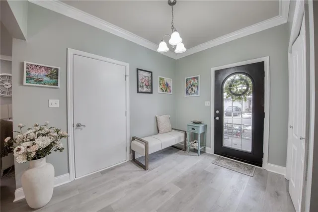 a living room with furniture and a chandelier