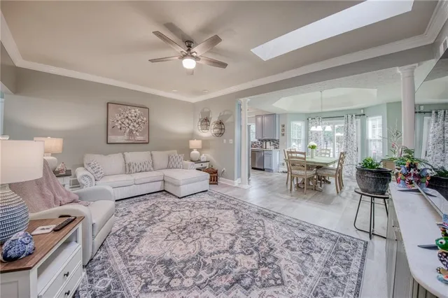 a living room with furniture and a dining table