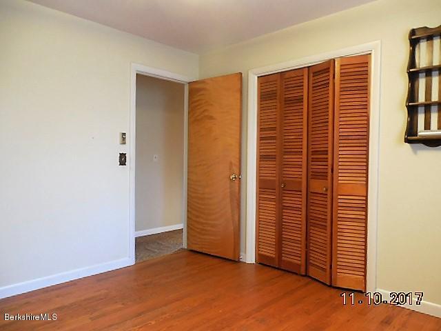184 Washington Mountain Road Lee, MA 01238 - Photo 14 of 26 an empty room with wooden floor and closet