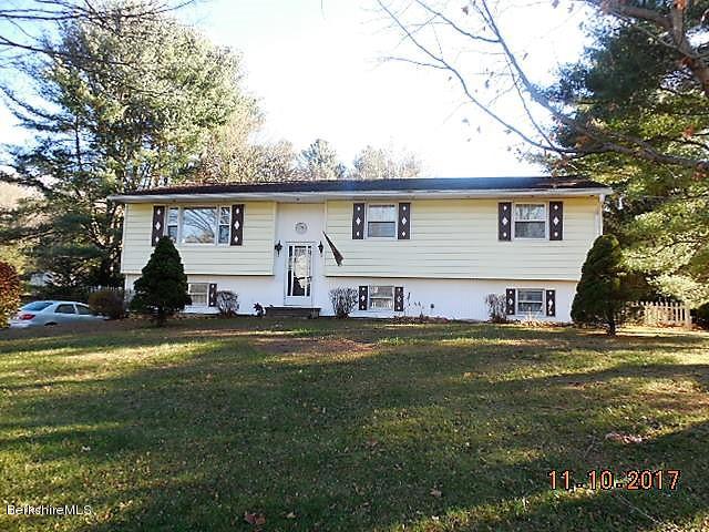 184 Washington Mountain Road Lee, MA 01238 - Photo 26 of 26 a front view of a house with a garden and trees
