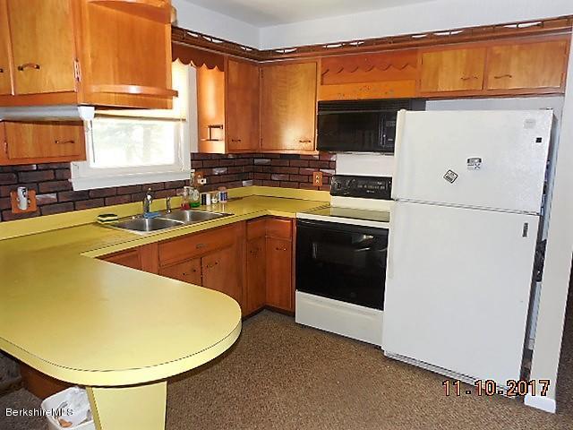 184 Washington Mountain Road Lee, MA 01238 - Photo 5 of 26 a kitchen with a sink appliances and cabinets