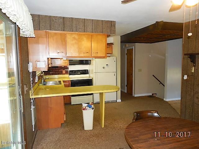 184 Washington Mountain Road Lee, MA 01238 - Photo 6 of 26 a room with stainless steel appliances kitchen island granite countertop a refrigerator and a stove