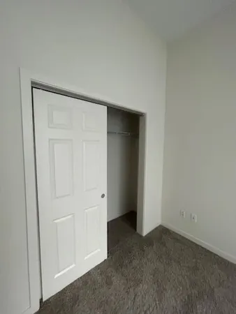 an empty room with closet area
