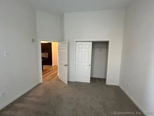 a view of an empty room and closet