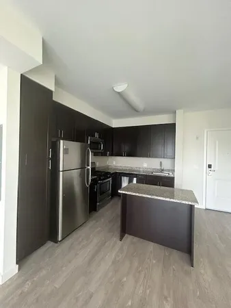 a kitchen with stainless steel appliances a refrigerator and a stove