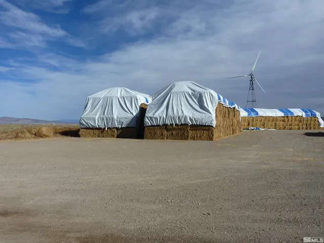 a front view of a house with cars