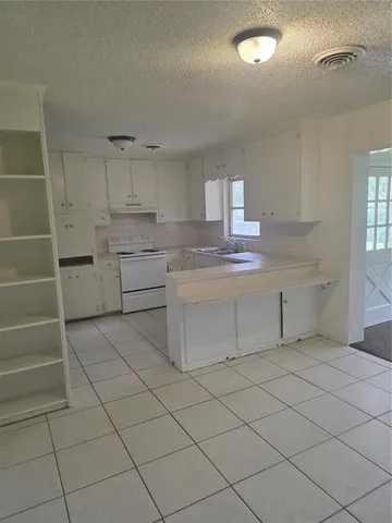 a kitchen with cabinets and appliances