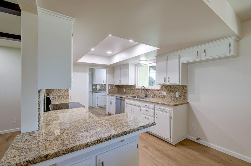 351 North Peach Avenue Clovis, CA 93612 - Photo 12 of 34 a kitchen with stainless steel appliances granite countertop a sink stove and cabinets