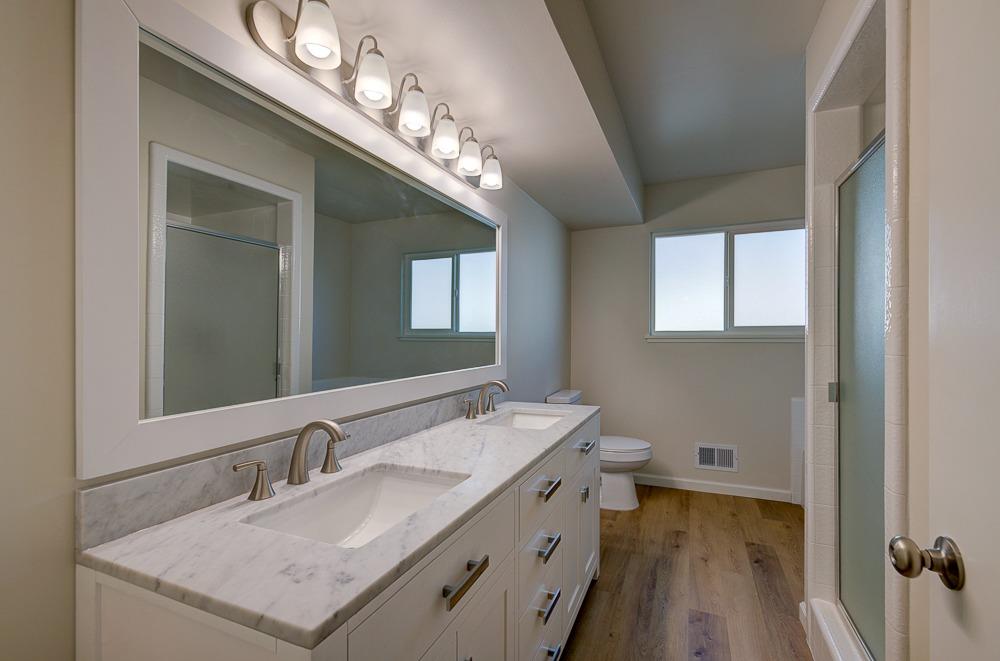 351 North Peach Avenue Clovis, CA 93612 - Photo 22 of 34 a bathroom with a double vanity sink and a mirror