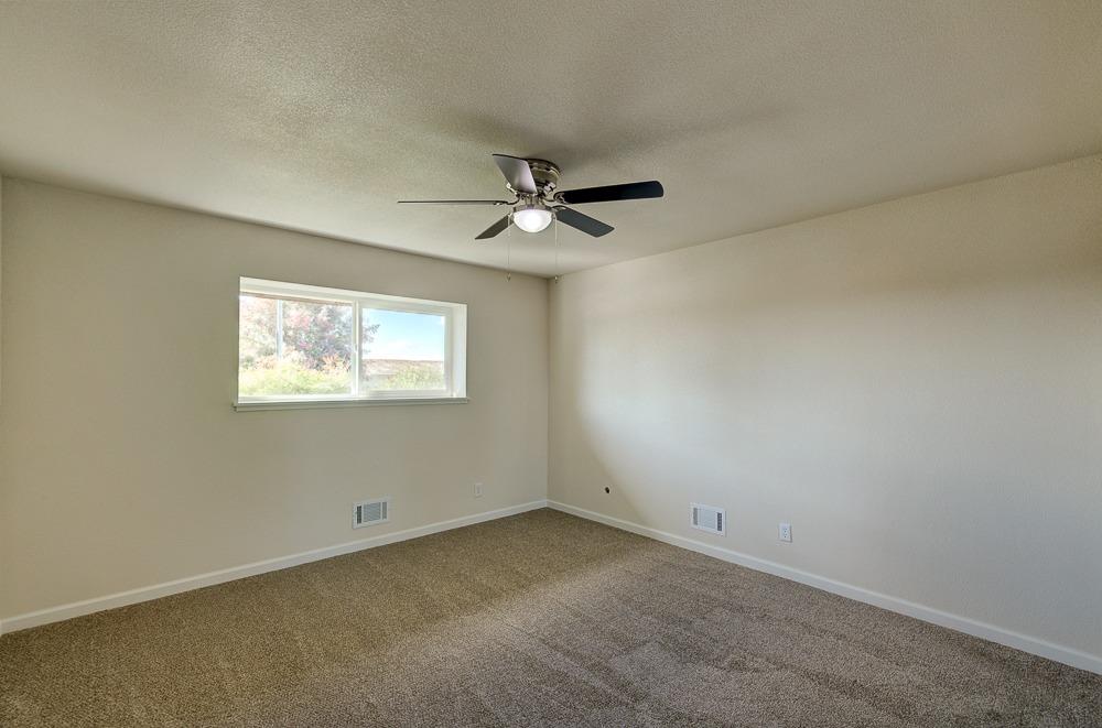 351 North Peach Avenue Clovis, CA 93612 - Photo 23 of 34 an empty room with a ceiling fan and window