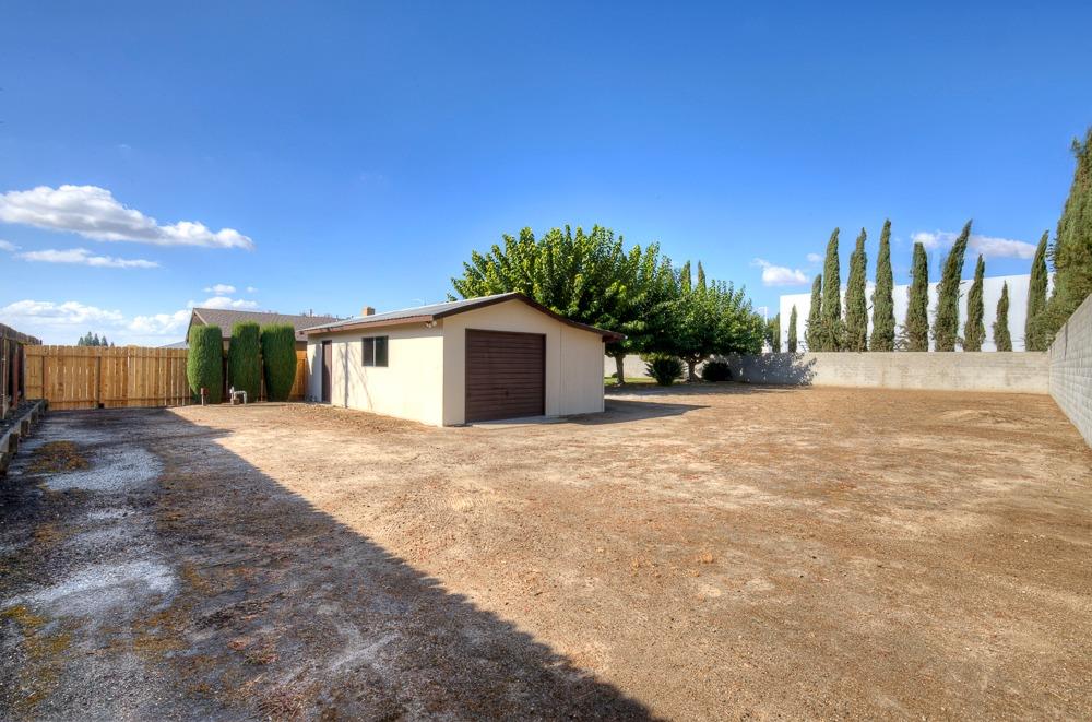 351 North Peach Avenue Clovis, CA 93612 - Photo 31 of 34 a front view of a house with a yard and garage
