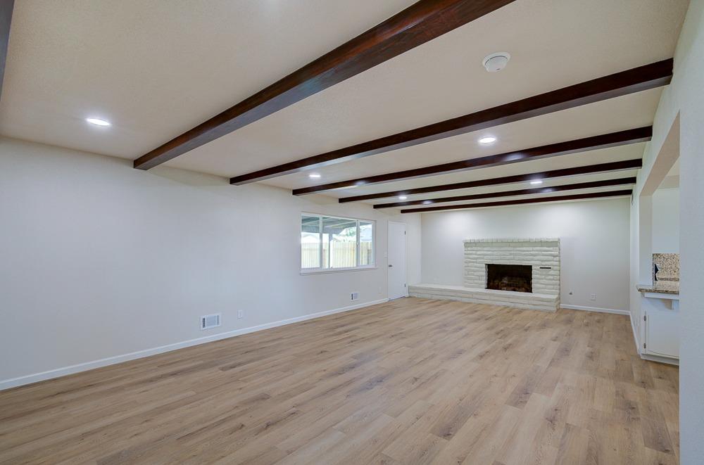 351 North Peach Avenue Clovis, CA 93612 - Photo 5 of 34 an empty room with wooden floor and a window