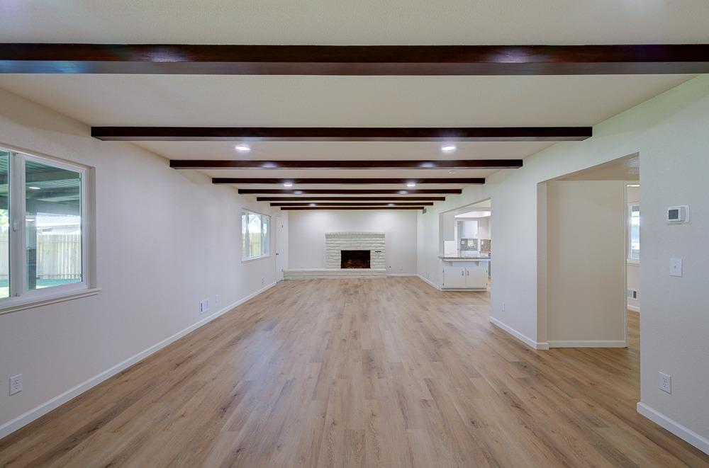 351 North Peach Avenue Clovis, CA 93612 - Photo 8 of 34 a view of empty room with wooden floor and fireplace