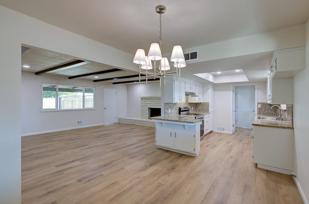 351 North Peach Avenue Clovis, CA 93612 - Photo 10 of 34 a view of a kitchen with a sink wooden floor and a kitchen