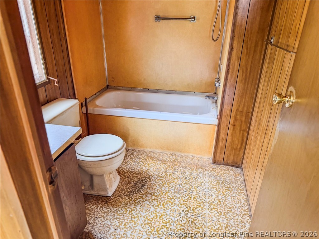 1308 Mac D Road Orrum, NC 28369 - Photo 10 of 32 a bathroom with a toilet and a shower