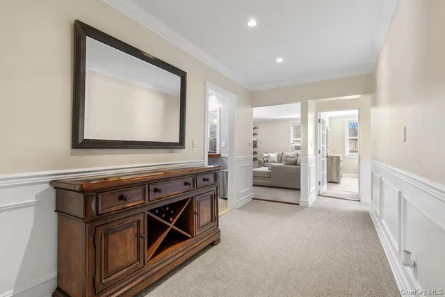 a view of an empty room and kitchen