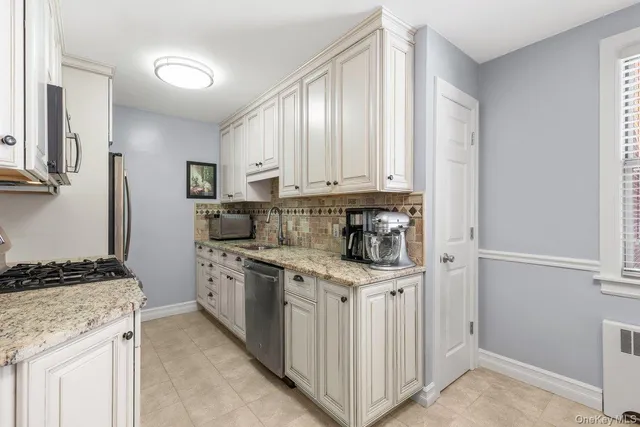a kitchen with stainless steel appliances granite countertop a stove and a refrigerator